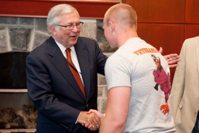 University President Charles W. Steger shakes student veteran's hand