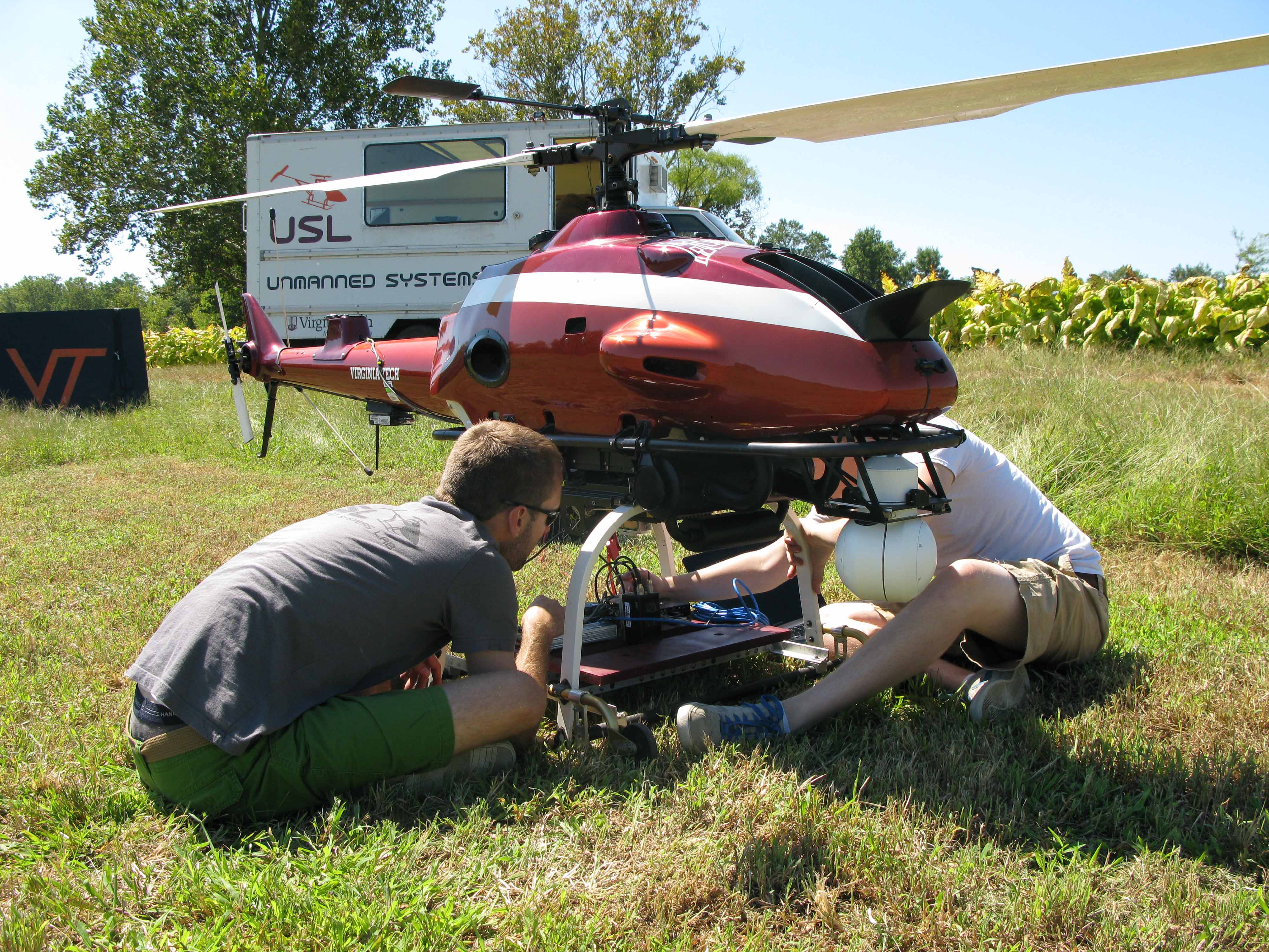 Mechanical engineering students prepare a helicopter for a research mission.