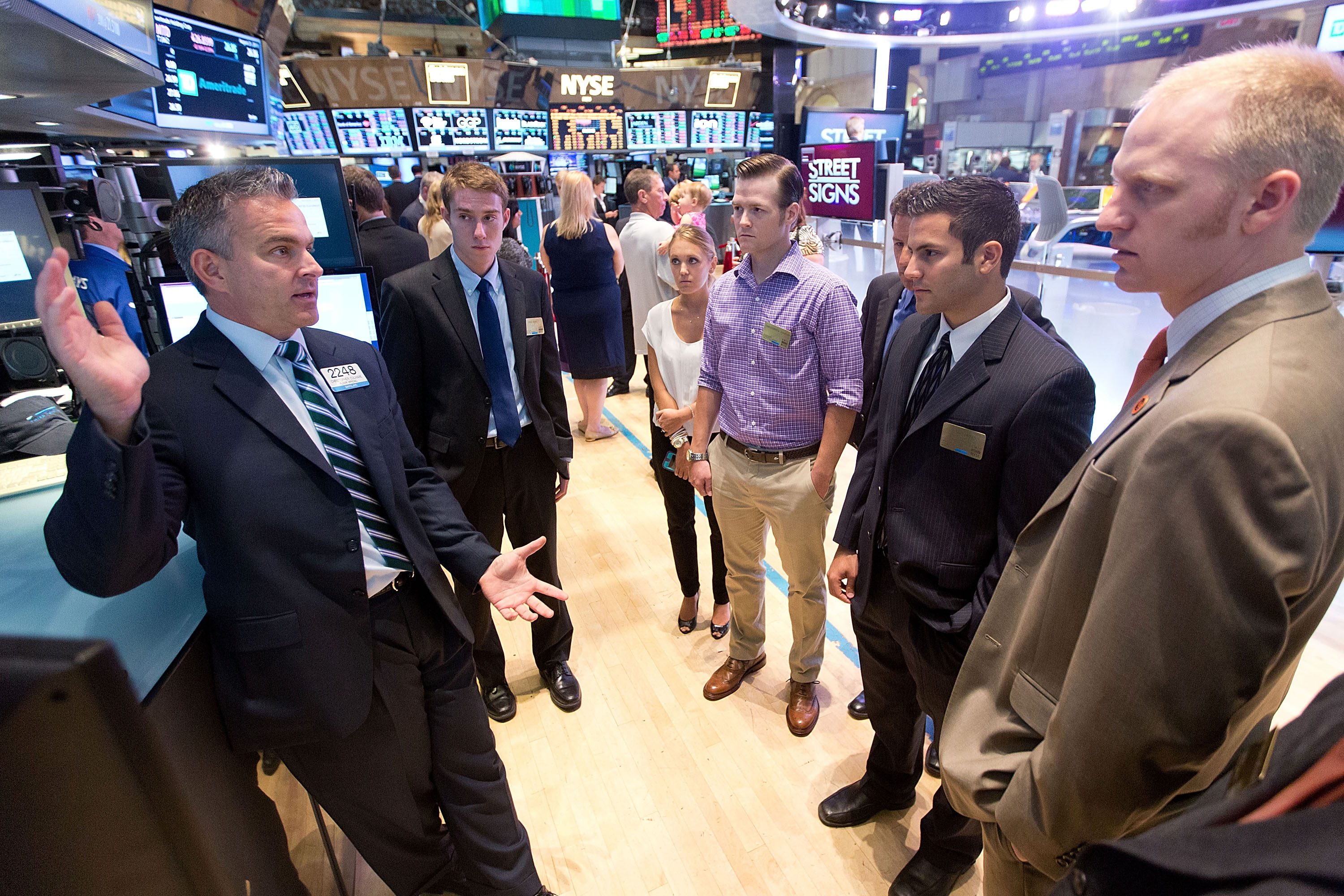 Eric Siss (second from left) and other scholarship winners listen to a floor trader during a tour of the New York Stock Exchange.