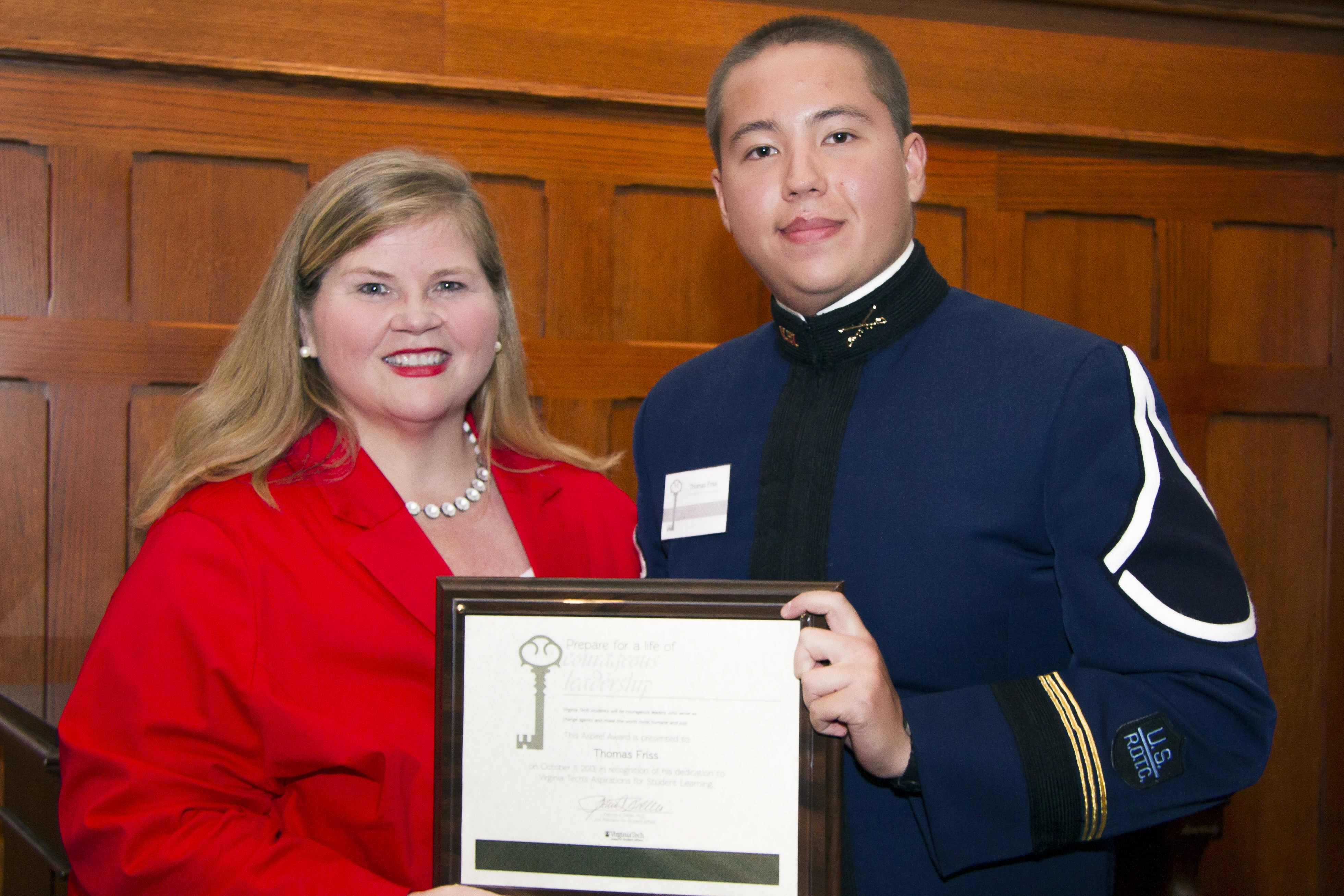 Patty Perillo presents award plaque to Cadet Thomas Friss