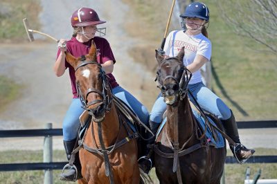 Students Jenny Schwartz and Christine Pankow practice playing polo at the home base of Polo Club at Virginia Tech. 