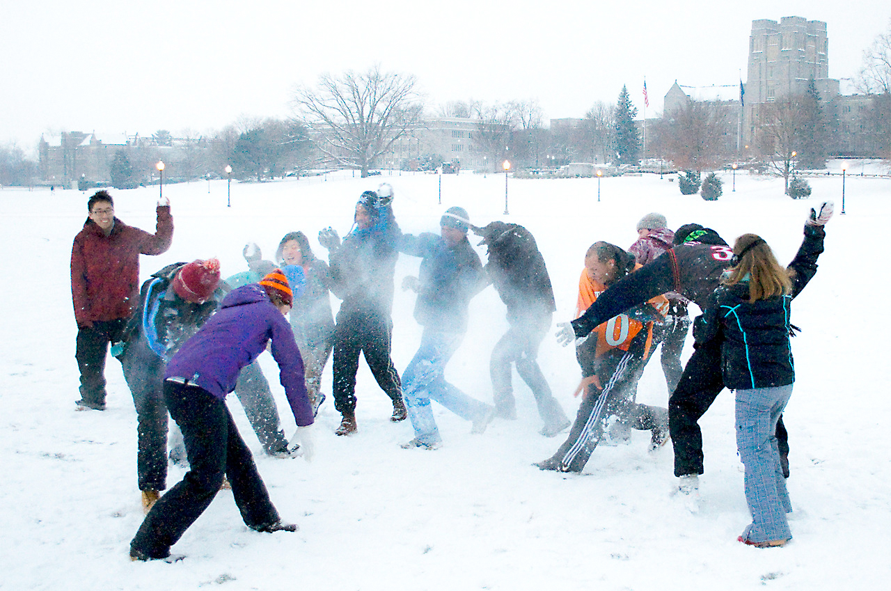 Students engage in a friendly winter snowball fight.