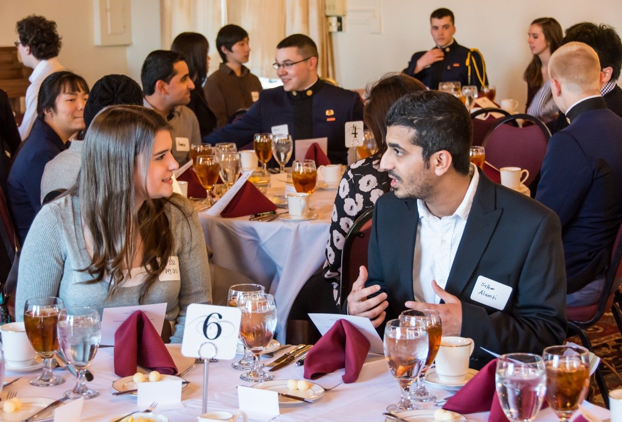 Virginia Tech Language and Culture Institute student Sultan Alamri, right, talks with University Honors Program student Larissa Perara during the dinner at Hillcrest Hall.