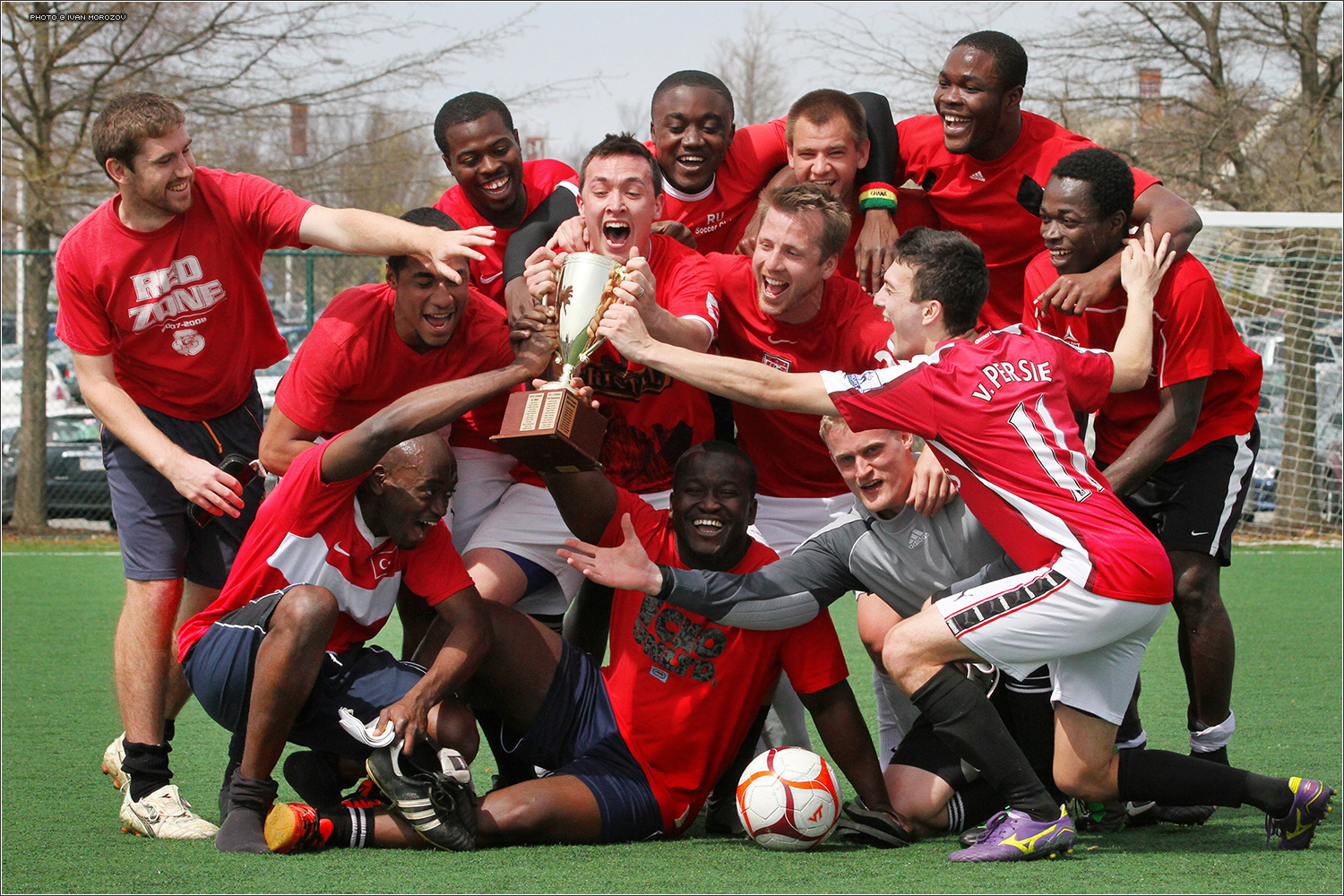 Soccer team poses with tournament trophy