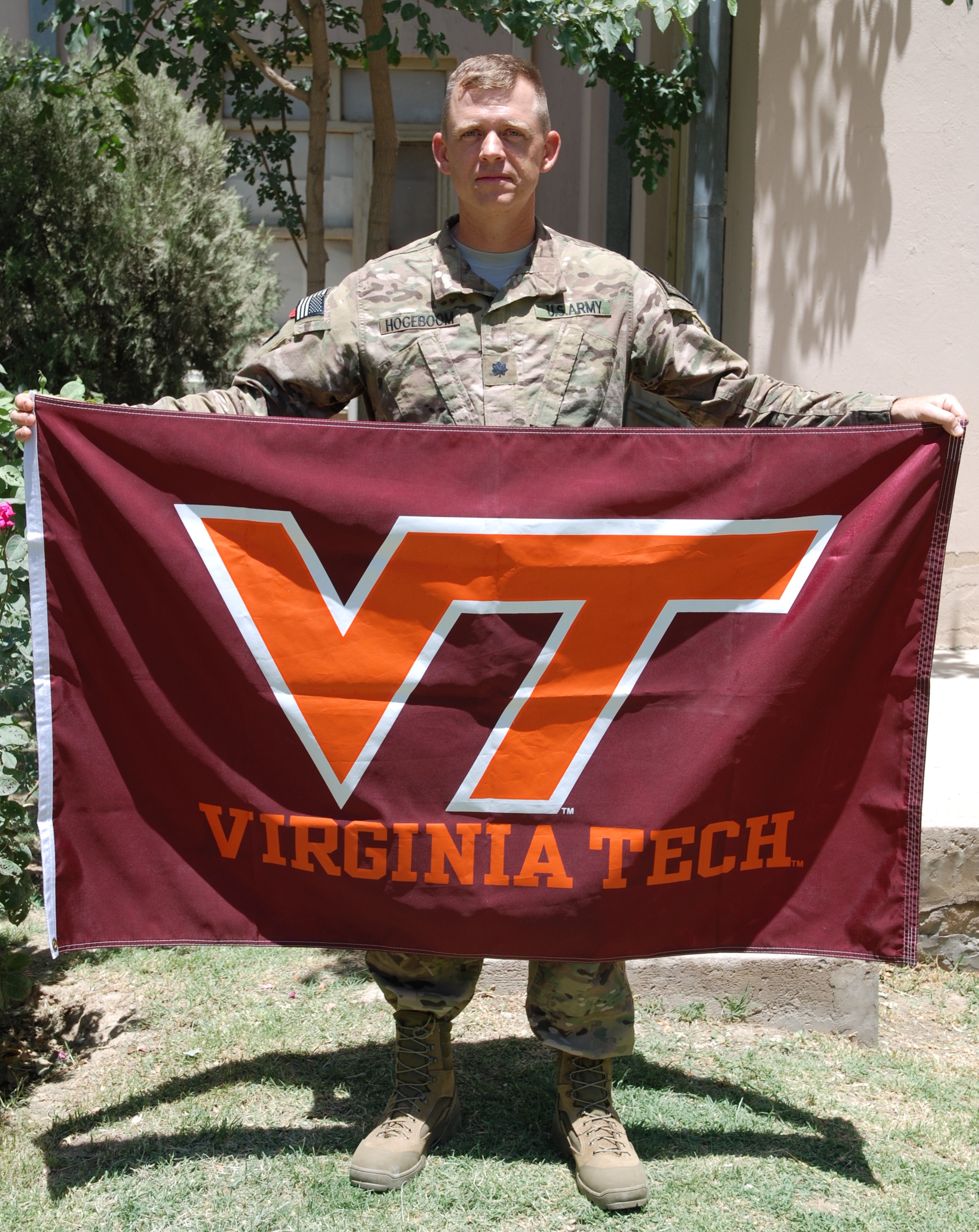 Lt. Col. Patrick Hogeboom, U.S. Army, Virginia Tech Corps of Cadets Class of 1994 holding the VT flag