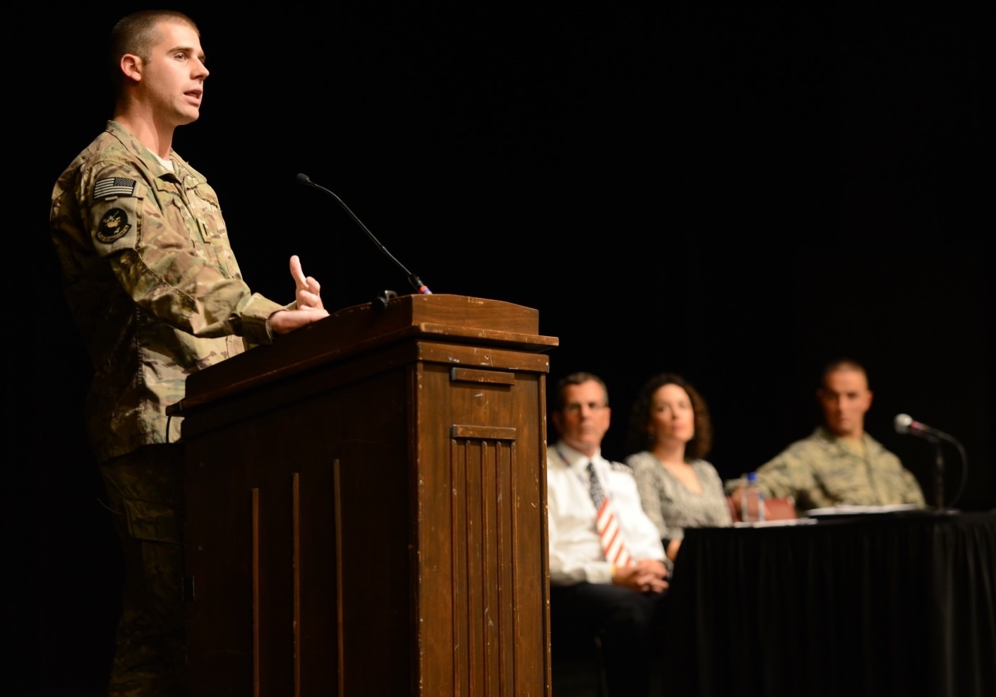 Returning alumni speak to the cadet regiment at the Fall 2013 Gunfighter Panel in the Burruss Hall auditorium.