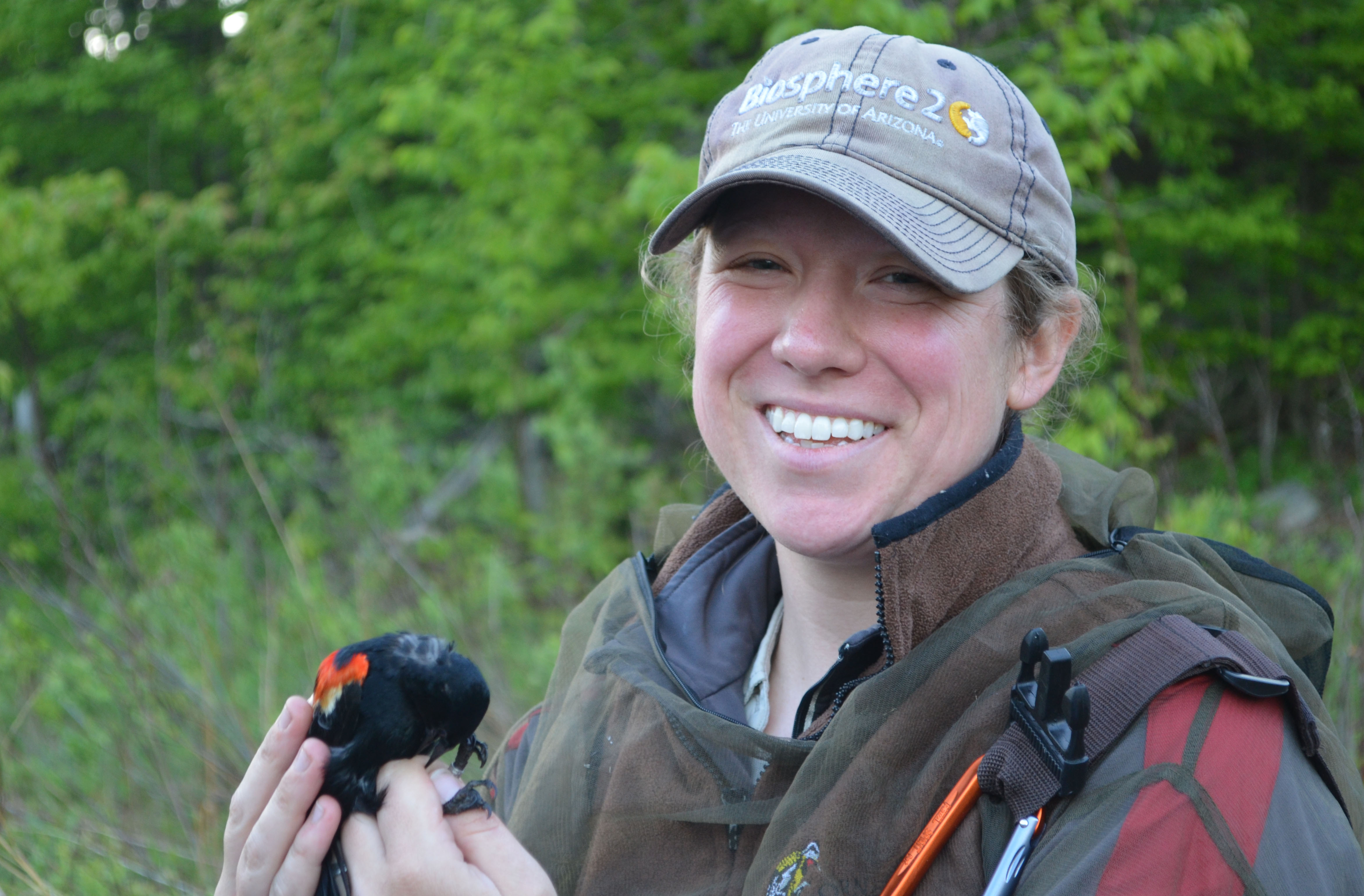 Laura Schoenle holds a red-winged blackbird
