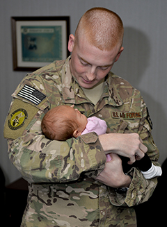 US Airman holding a baby.