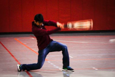 A player swings the cricket bat during practice in the gym.