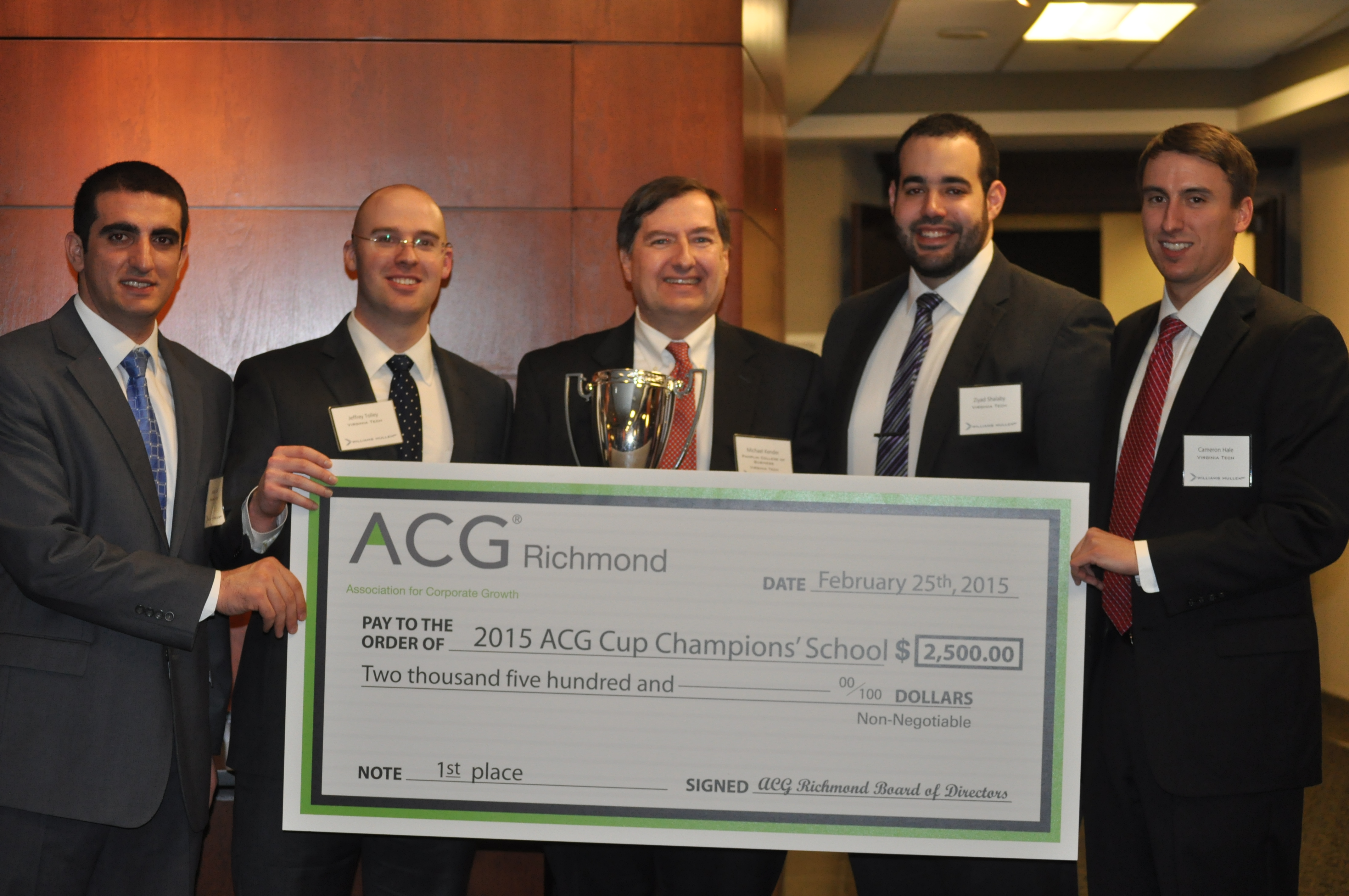 Finance professor Mike Kender (center) with Pamplin MBA students (from left to right) Ardian Daku, Jeffrey Tolley, Ziyad Shalaby and Cameron Hale with the ACG trophy and check.