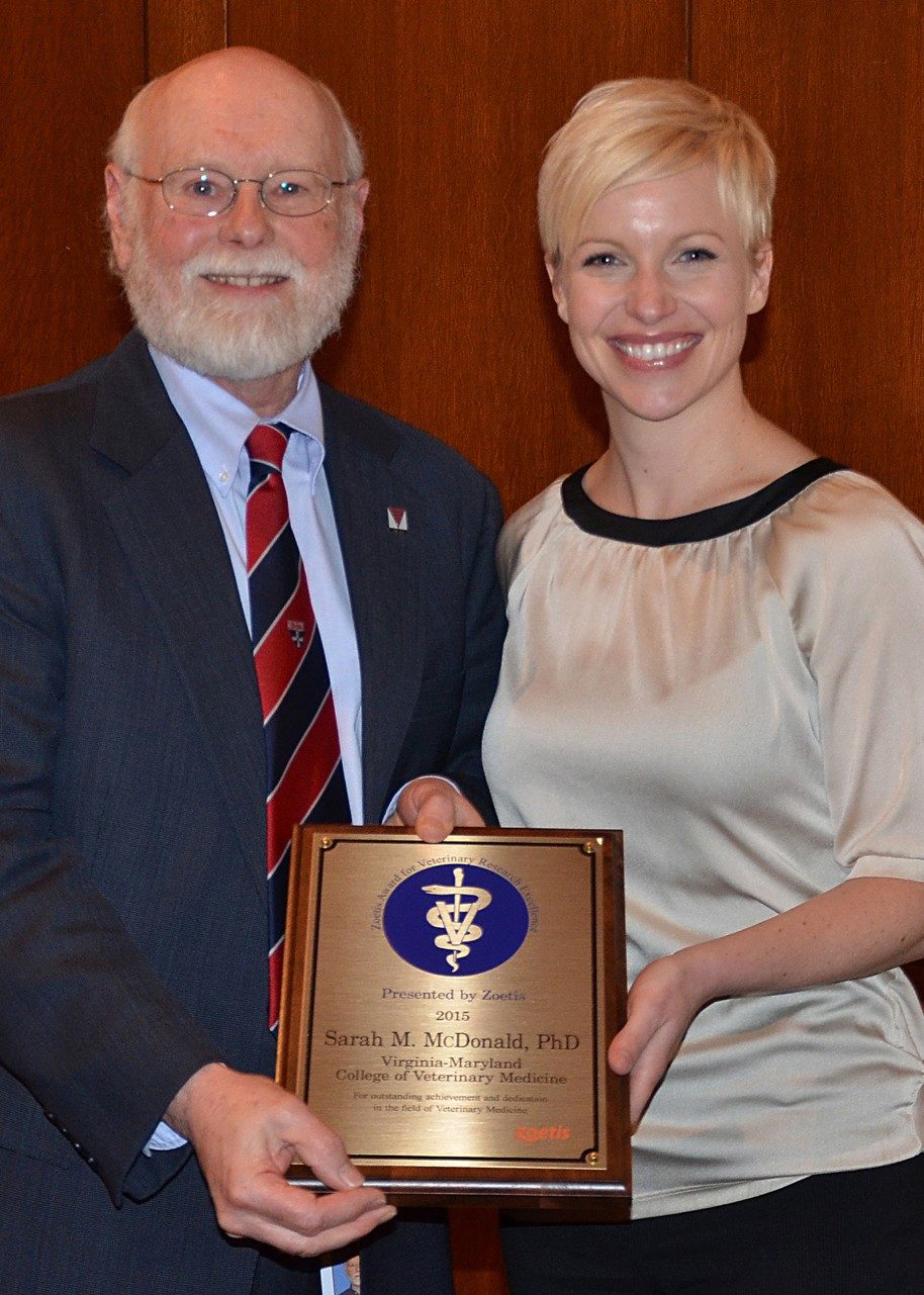 Roger Avery, senior associate dean for research and graduate studies, presents Sarah McDonald with the 2015 Zoetis Award for Research Excellence.