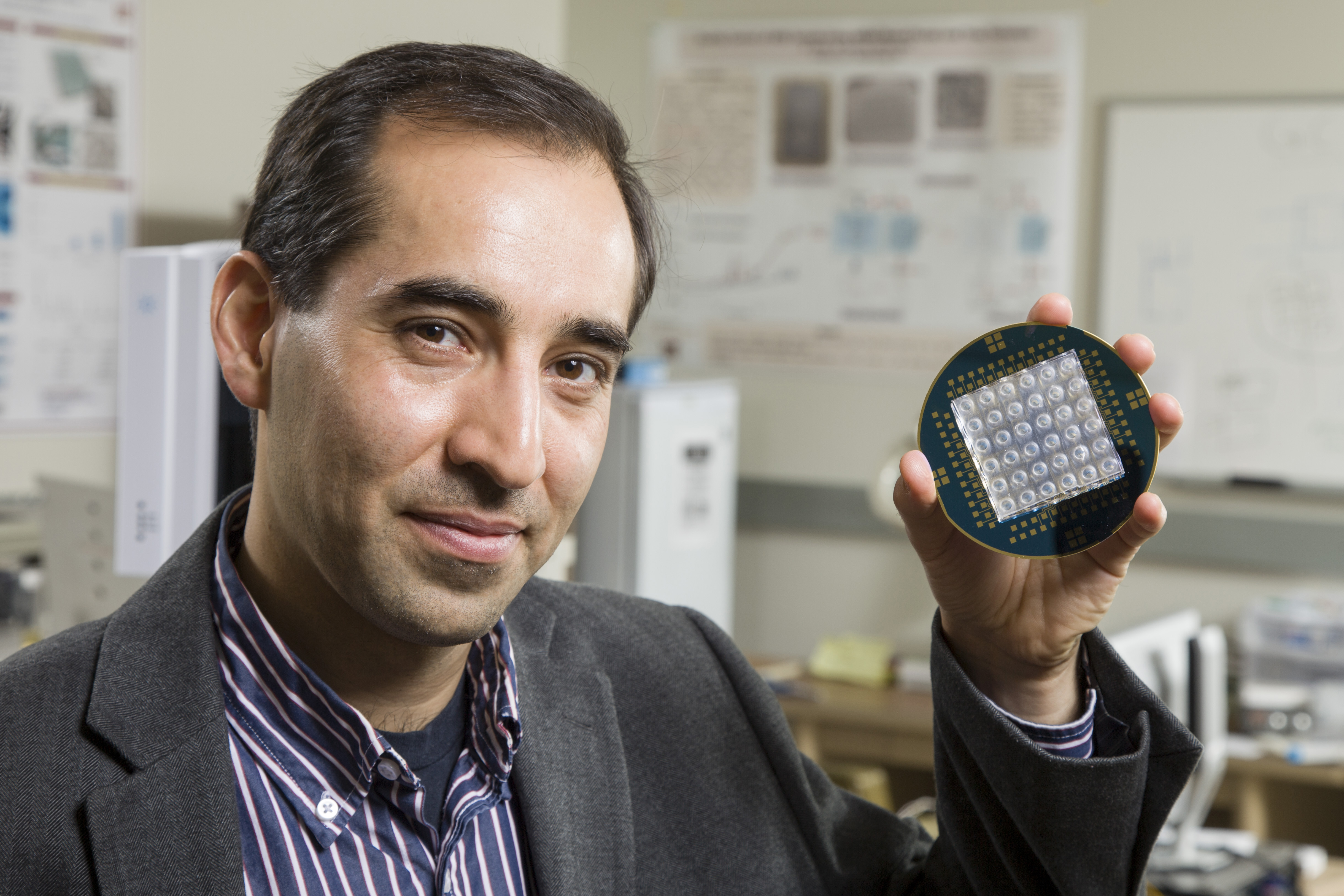 Masoud Agah holds microelectrode array