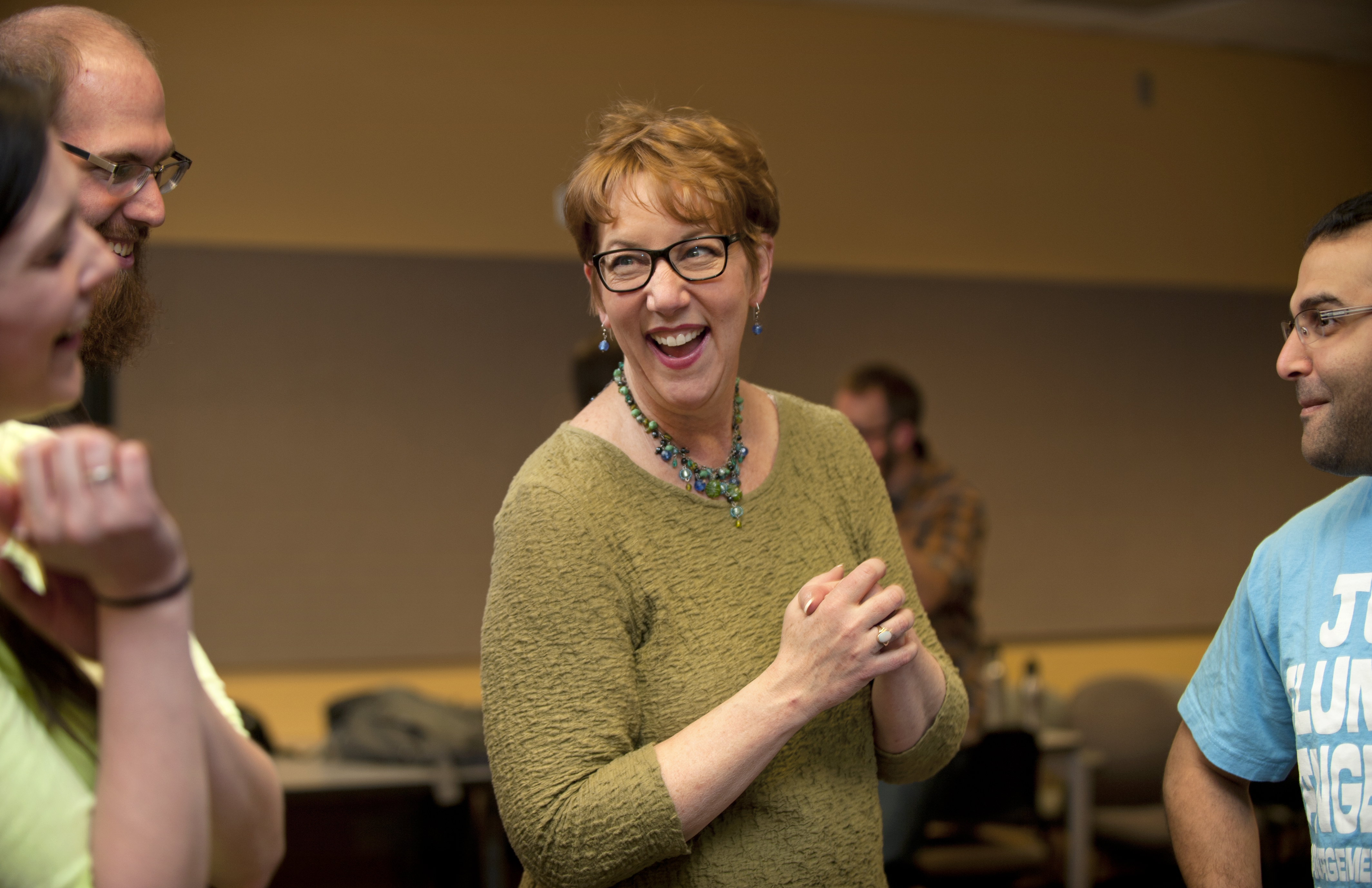 Patricia Raun laughs with students during her Communicating Science class.