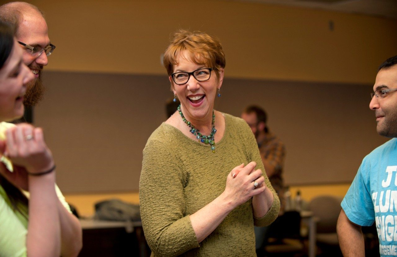 School of Performing Arts Director and Communicating Science instructor Patricia Raun laughs with students during a recent session of the class.