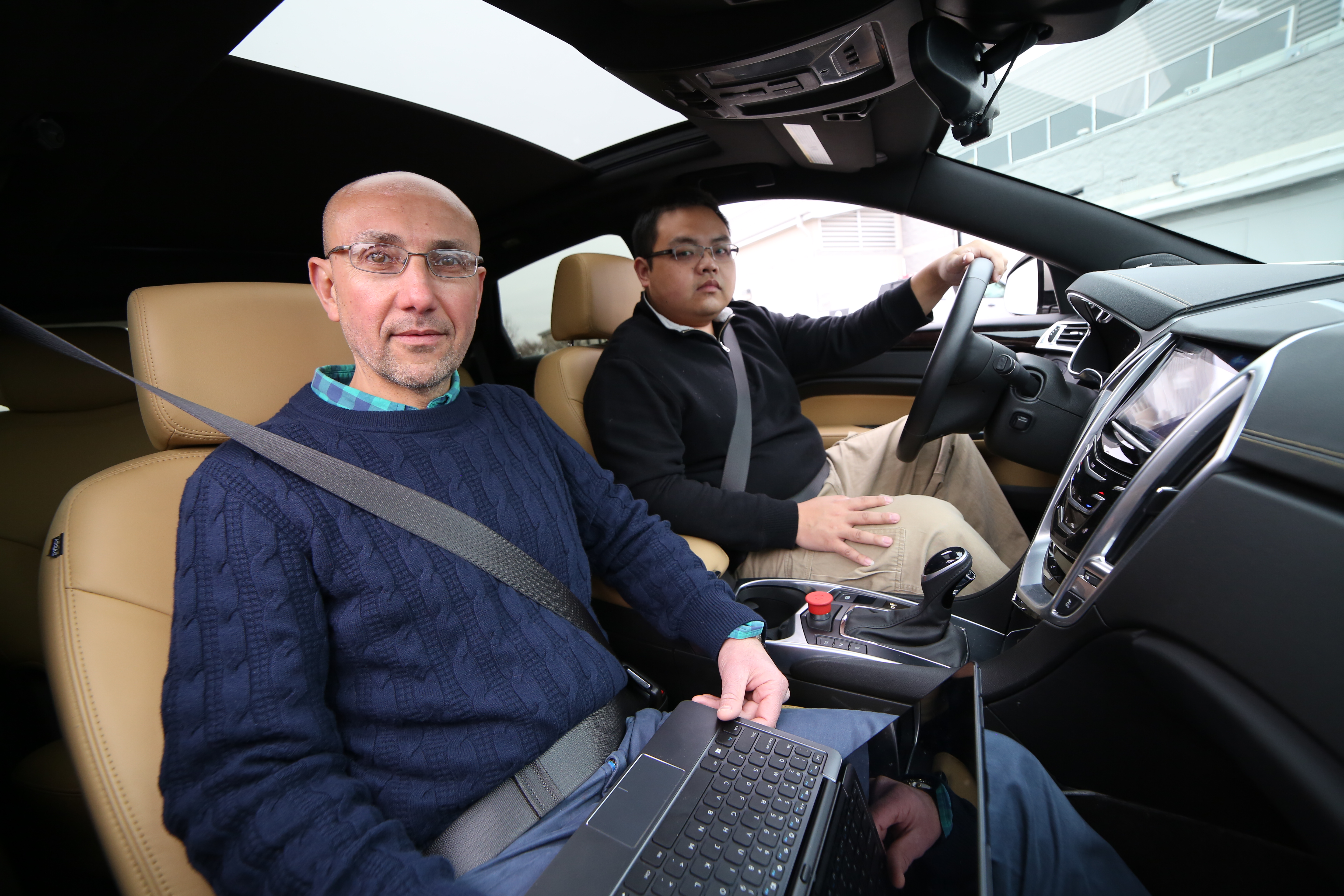 Hesham Rakha, at left, and Hao Chen sit in a test vehicle