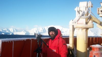 A wider view of Iskander Ismailov, an assistant research professor at the Virginia Tech Carilion Research Institute, filming from the deck of a research vessel in the Southern Ocean. 