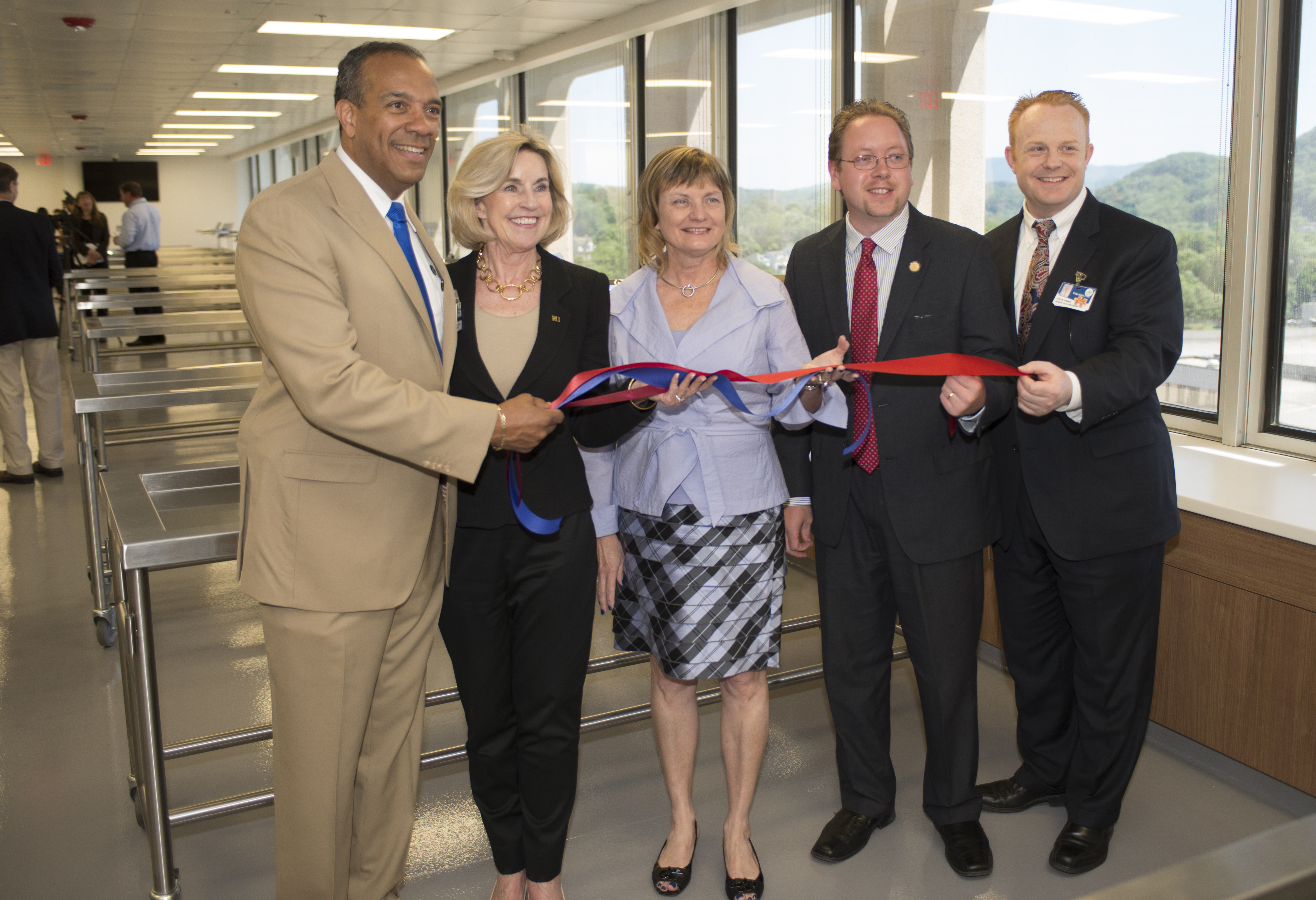 Holding the cut ribbon were Nathaniel L. Bishop, president of Jefferson College of Health Sciences; Penelope Kyle, president of Radford University; Dr. Cynda Johnson, dean of the Virginia Tech Carilion School of Medicine; Delegate Joseph Yost; and Steve Arner, senior vice president and chief operating officer of Carilion Clinic