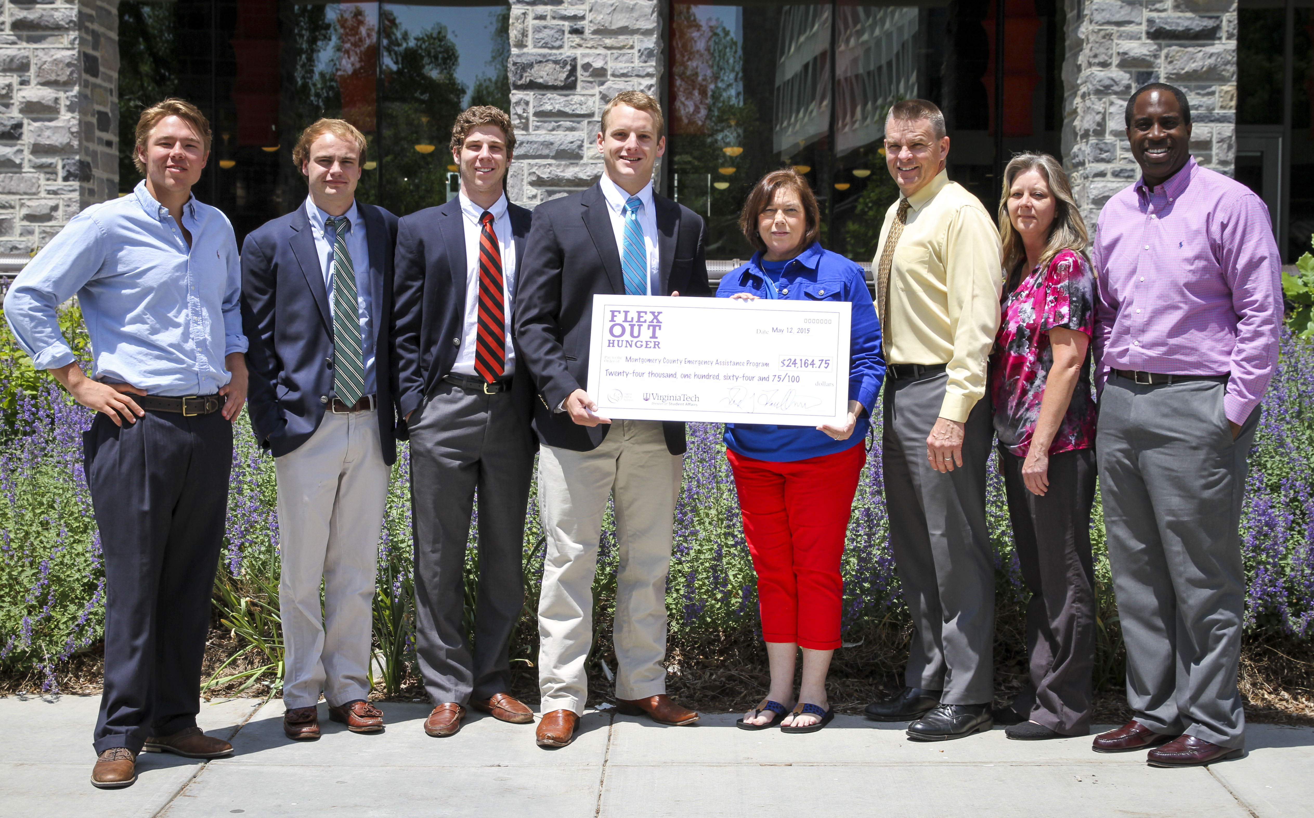 Group image of SAE members and recipients of check. 