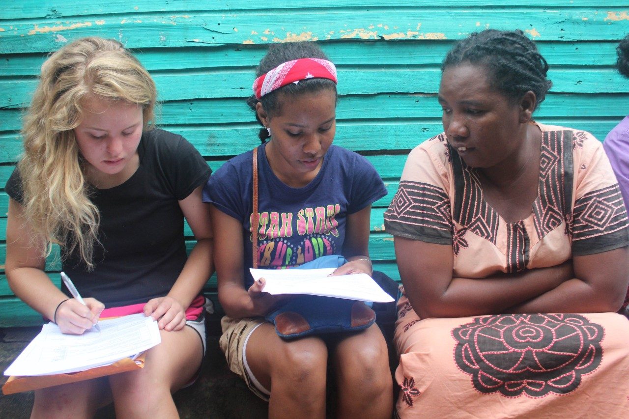 In Madagascar, SURF student Keely O'Keefe, at left, worked with translators such as Jumelle Tsifanay, at center, to communicate with local people about their diets. Photo by Hailey Boone.