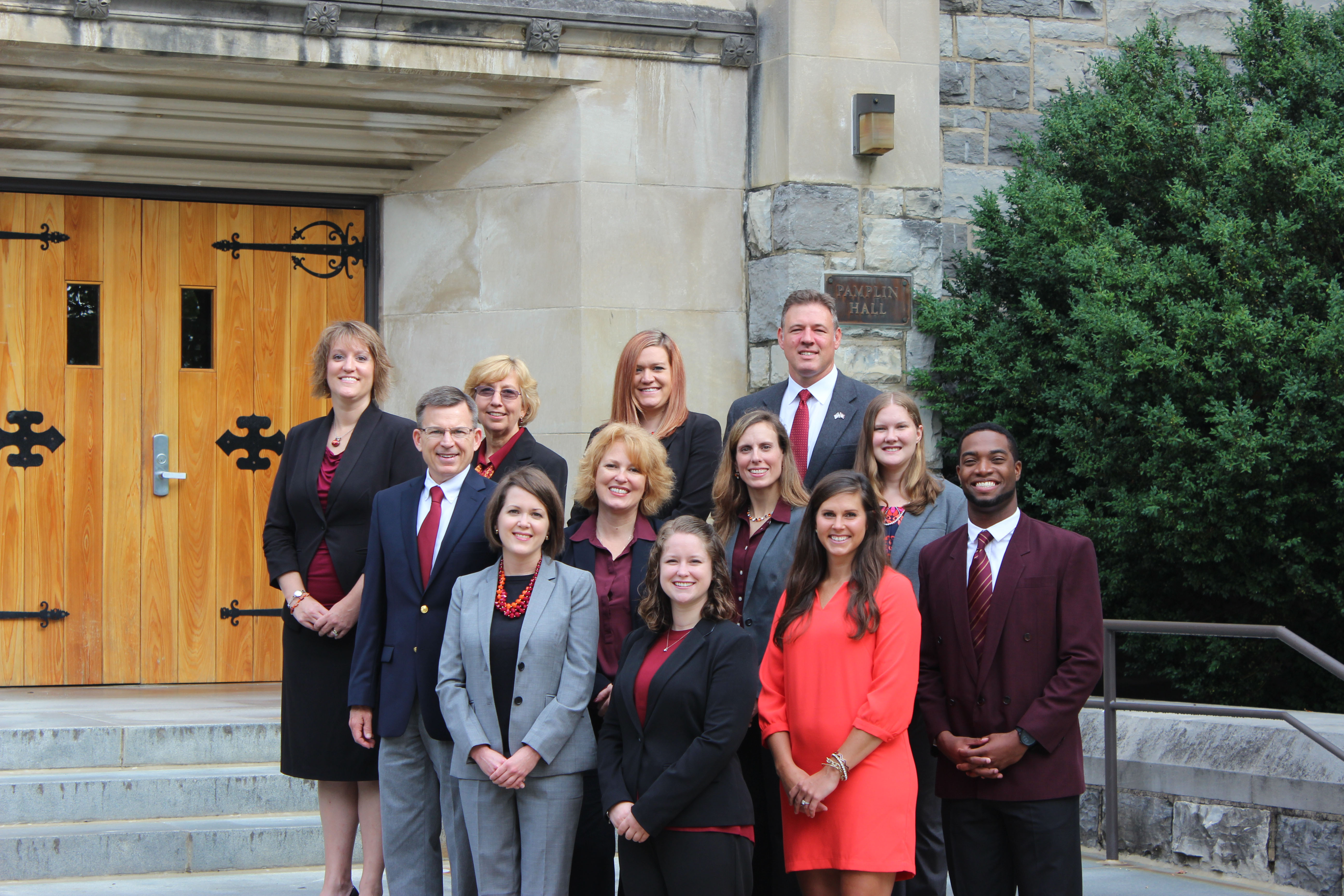The Pamplin academic advising team pose outside Pamplin Hall. (L to R) Back Row: Leigh Anne Byrd, Lorraine Borny, Lindsey Ramey, Justin Monday; Middle Row: Keith Gay, Jennifer Clevenger, Kirsten Mosby, Christina Minford; Front Row: Kelley Ausman, Alison Wade, Katie Wells, Lorenzo Williams