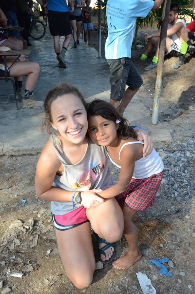 Anastasia poses with a child in Honduras