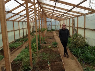 Travertine Orndorff checks out a greenhouse in Chile as part of her planning and research to build an educational garden for a school there.