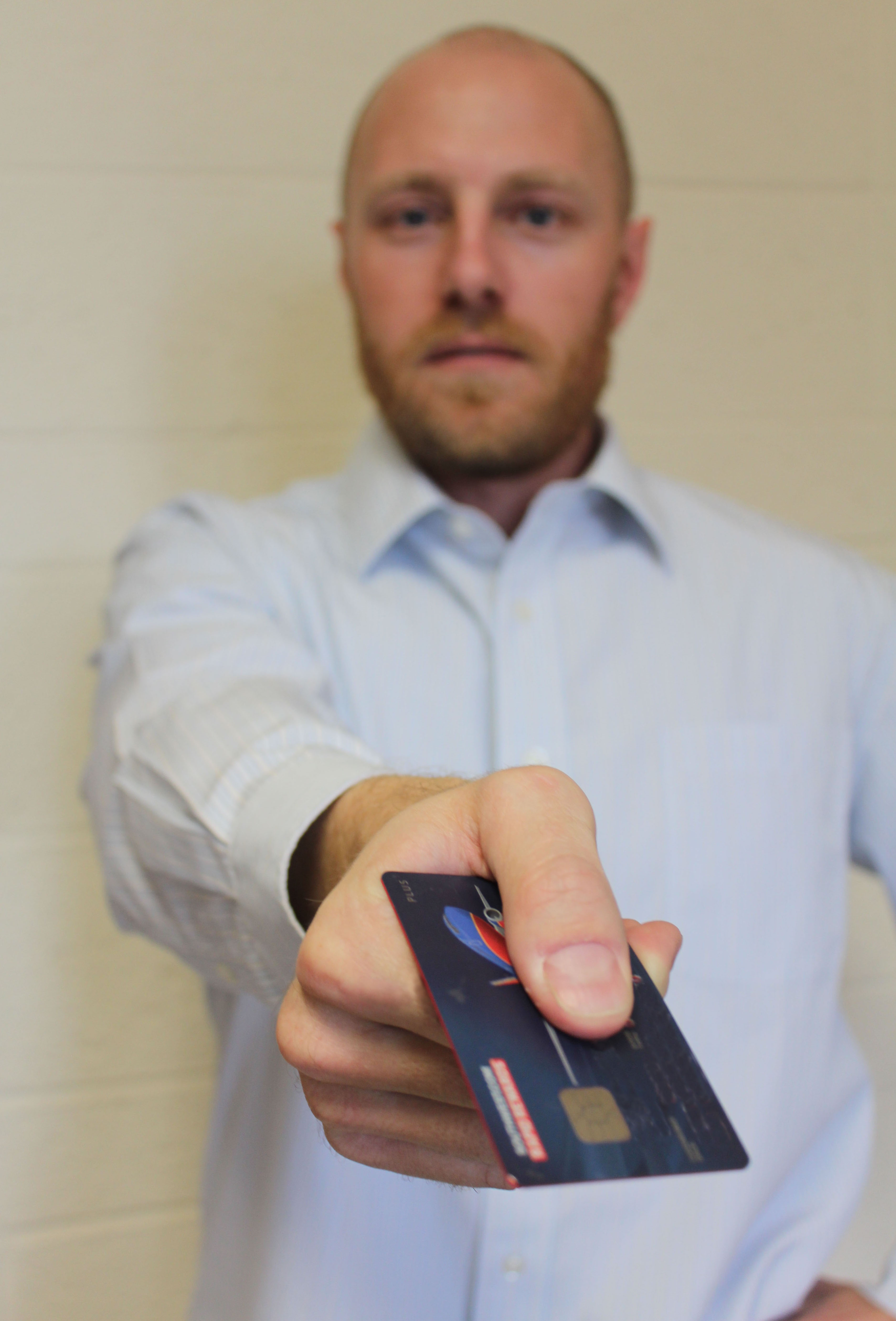 Man holds a credit card with a chip on it.