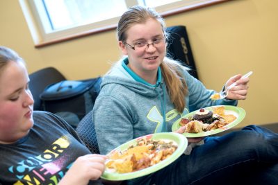 Students eat food made from invasive species.