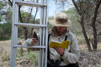 When David Millican, a doctoral candidate in biological sciences in the College of Sciences, goes out in the field, he always takes his four most trusty tools: a ladder, peeper camera, GPS device, and a journal for recording GPS candidates.  Photo by Jelena Djakovic.
