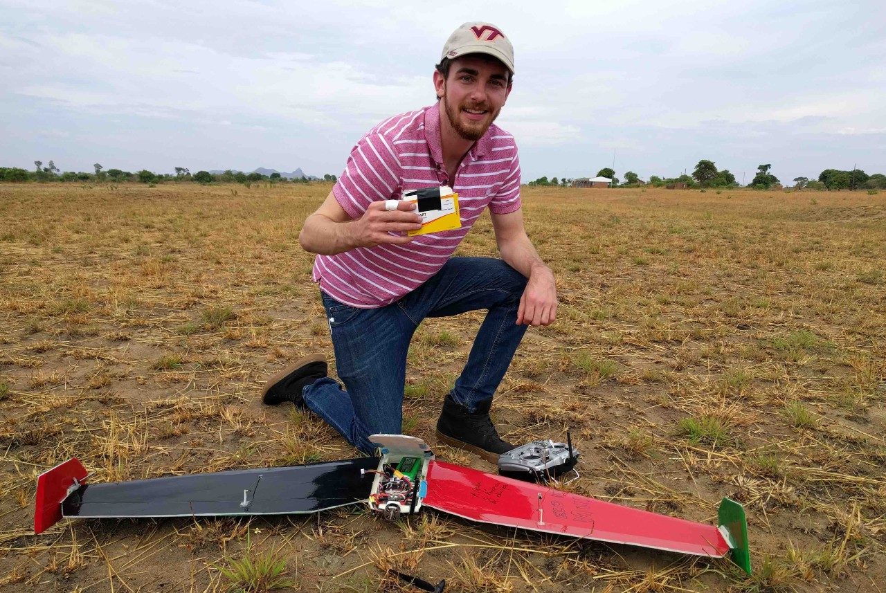 Zack Standridge, a graduate student with the Kevin T. Crofton Department of Aerospace and Ocean Engineering, holds the simulated medical package delivered by the autonomous drone.