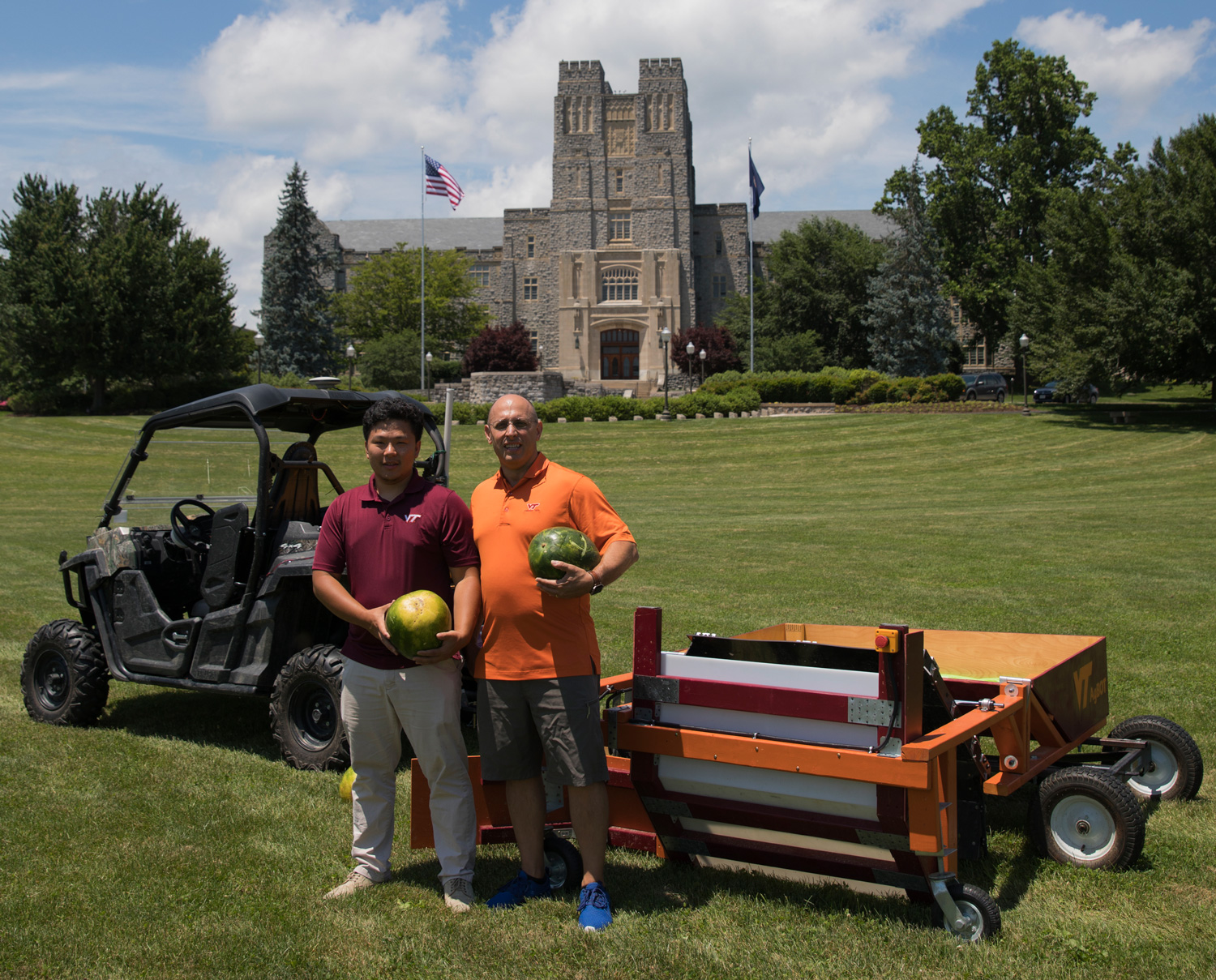 Hongxu “Howard” Guo (left), a double major in mechanical and electrical engineering, and Alex Leonessa, mechanical engineering professor and advisor of the Virginia Tech agBOT team, with the autonomous watermelon harvester.