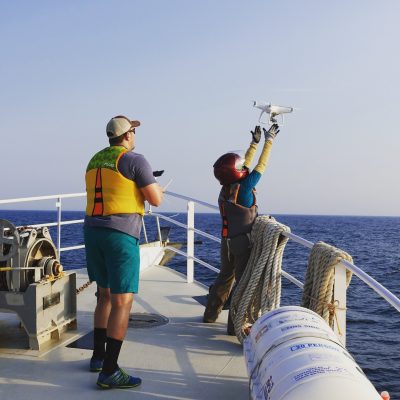 A drone is deployed of the side of a research vessel in the Atlantic Ocean to monitor the transport of a released dye. Such measurements can be used to predict the transport of hazardous agents in the water.  Photo courtesy of David Schmale.
