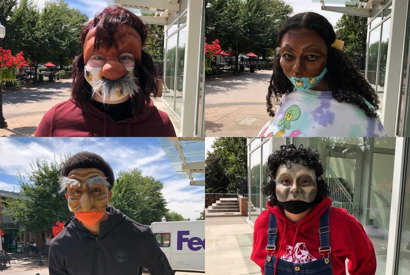 Four university students wearing commedia del arte style masks, each standing outside.