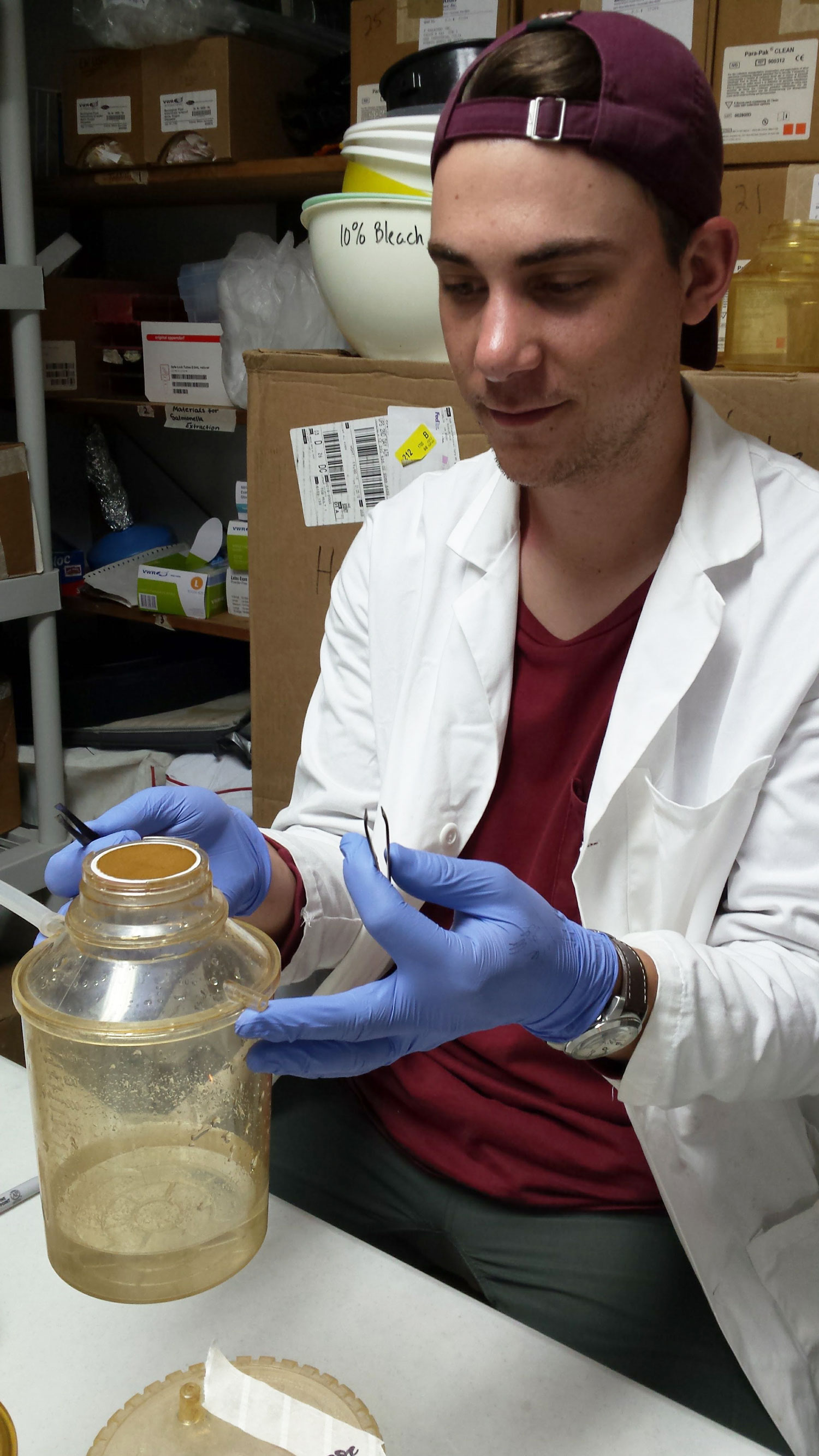 Davis filtering water samples in the InterAmerican University lab.