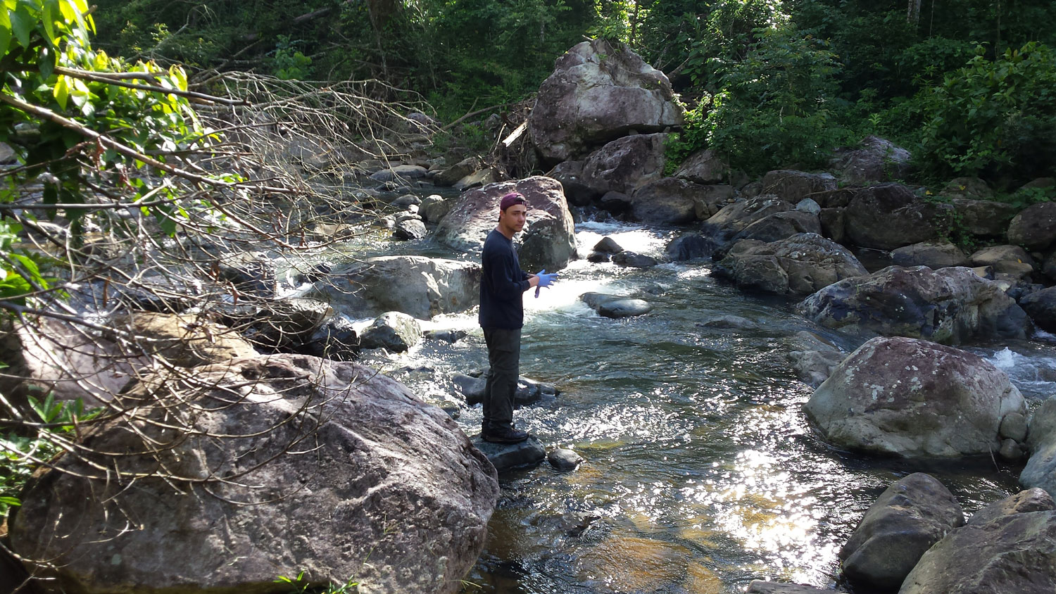 Civil engineering doctoral student Benjamin Davis takes water samples from the Rio Marin River in Patillas, Puerto Rico in early 2018.