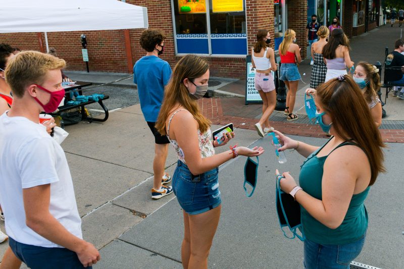Brianna Romagnano and other members of the COVID Crushers group hand out masks, hand sanitizer, and resources in downtown Blacksburg. The COVID Crushers are Virginia Tech students who spent Friday evenings this semester giving out personal protective equipment and medical-related information to help fight the COVID-19 pandemic.