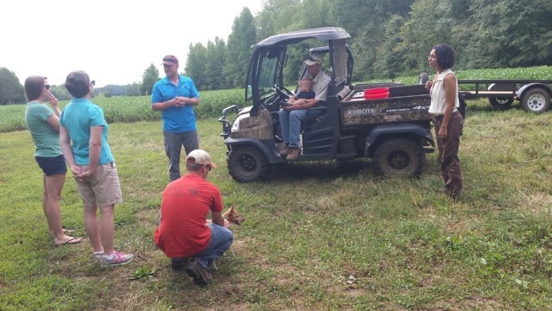 In this 2016 photo, Extension Agent Adam Downing talks with land owners about forest management