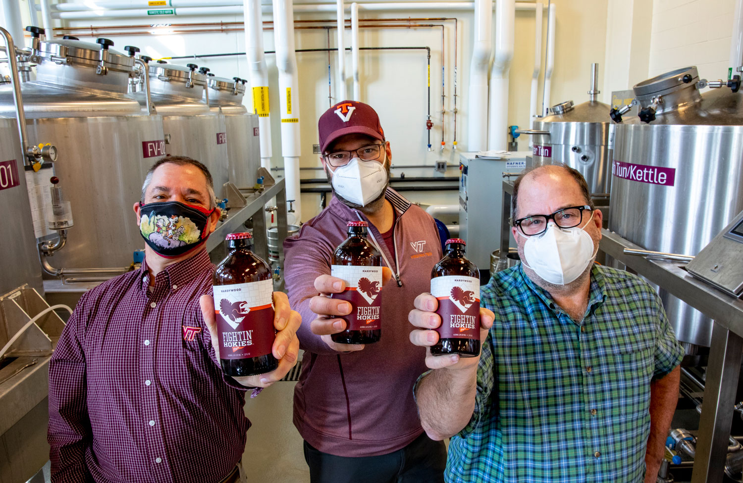 Three faculty members in the College of Agriculture and Life Sciences’ Department of Food Sciences and Technology collaborated to develop the recipe for Fightin’ Hokies Lager. From left, Herbert Bruce, Brian Wiersema, and Sean O’Keefe hold stubby bottles of the Fightin’ Hokies Lager. Zeke Barlow, Virginia Tech