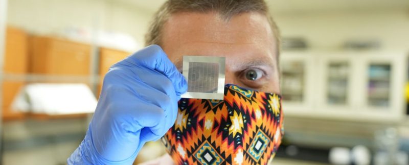 Researcher Jonathan Boreyko looks through a synthetic feather