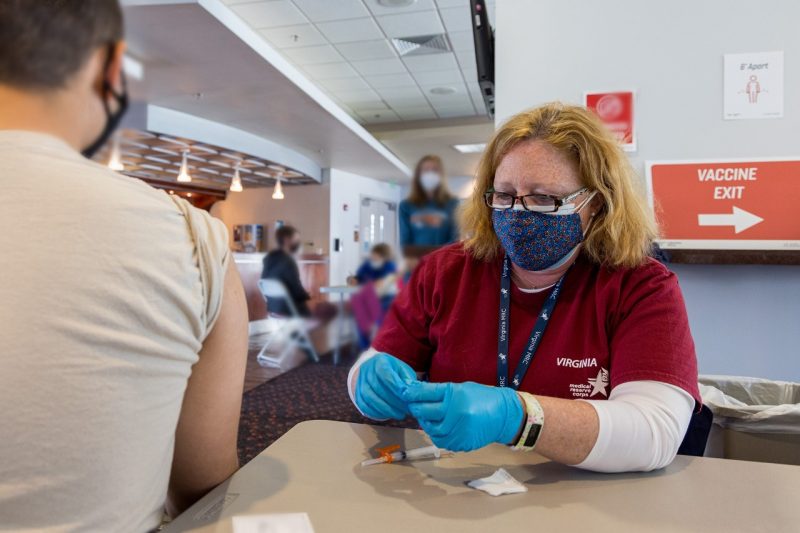 Rachael Carpenter prepares to vaccinate a Virginia Tech student at Lane Stadium.