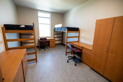 CID residence hall room with 2 desks, 2 bunks, and 2 desks