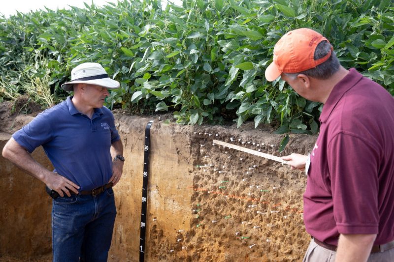 Chris Lawrence (left) and Mark Reiter discuss layers of soil at the 2021 Virginia Ag Expo at Corbin Hall Farm in Middlesex, Virginia. They are supporters of "4 The Soil," a collaborative effort to raise awareness of soil health.