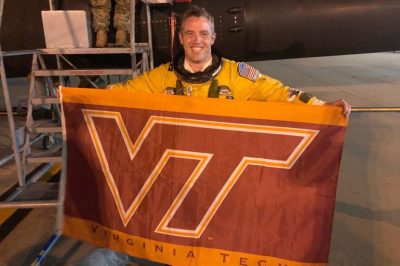 Maj. Sean Heatherman holds a Virginia Tech flag.