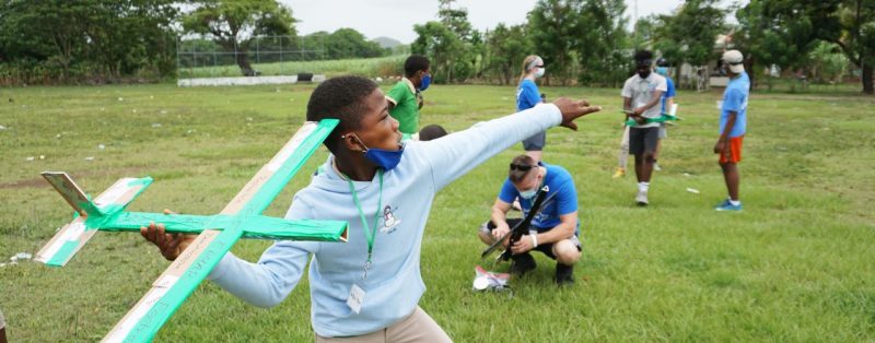 A student in the Dominican Republic launches a glider during a STEM class. Photo courtesy of Garrett Asper.