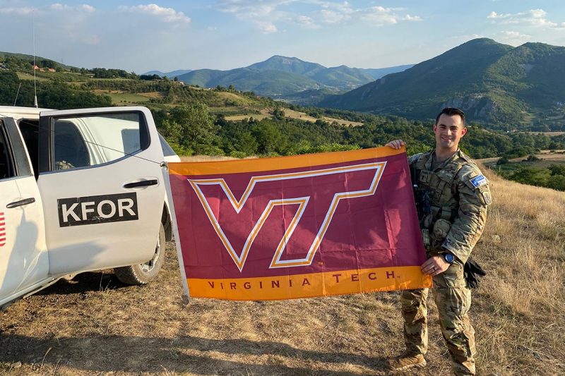 1st Lt. Thomas Meyer holds a Virginia Tech flag.