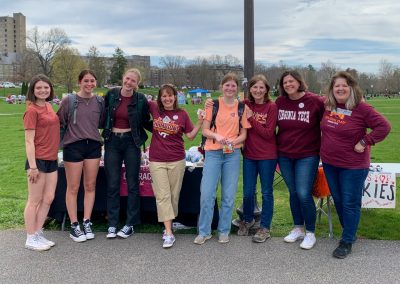 A group of Hugs for Hokies moms pose with some Virginia Tech students