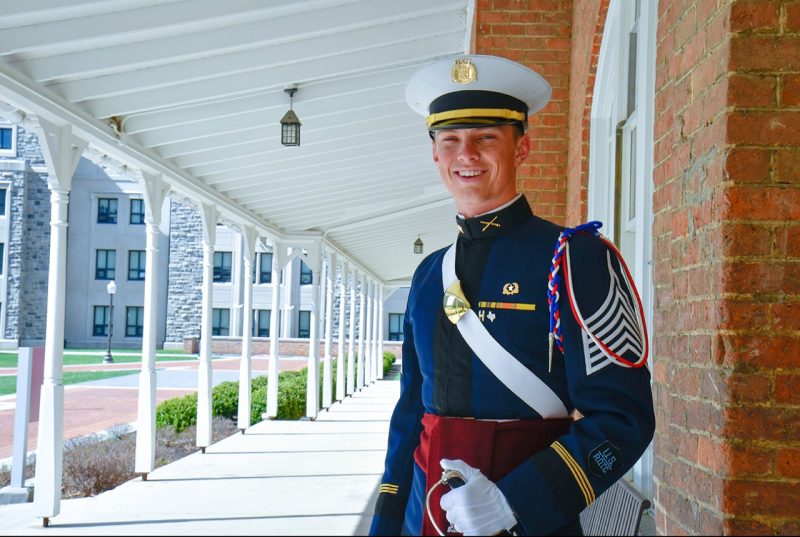 Cadet Austin Askew stands on the front porch of Lane Hall.