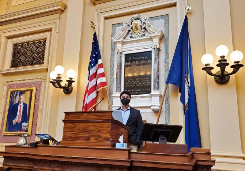 Student Saket Bikmal poses on the dais in the House Chamber at the Virginia State Capitol in Richmond.