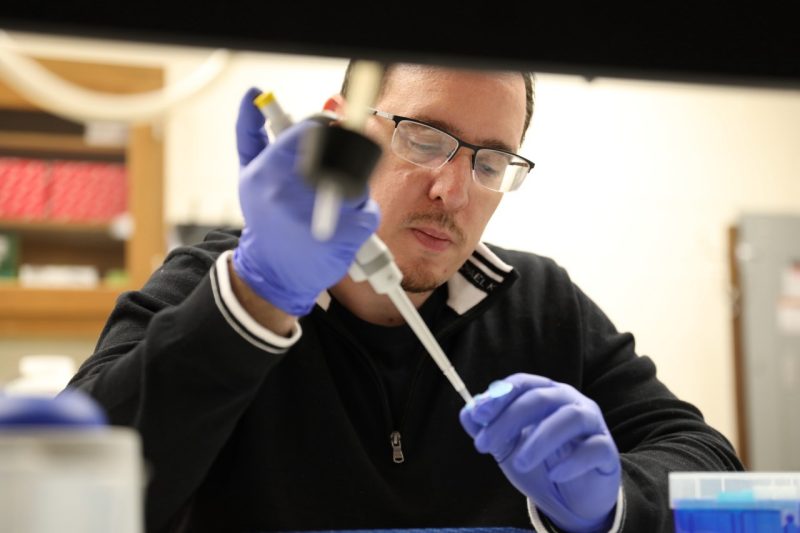 Man in black jacket in a scientific lab.