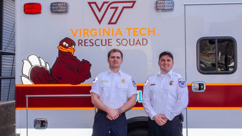 Virginia Tech Rescue Squad officers Nathan Duda (at left) and Connor Duda stand in front of the new ambulance.